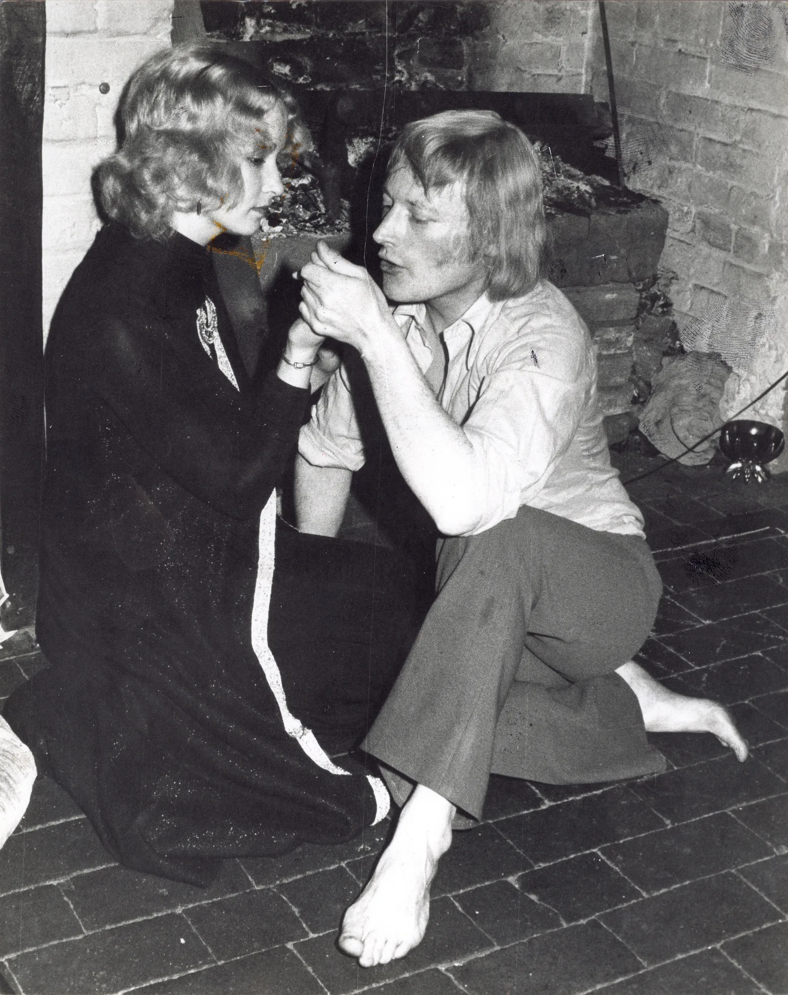 The visiting magician and a young coven member by the fire, Chantry Cottage, 23 April 1975