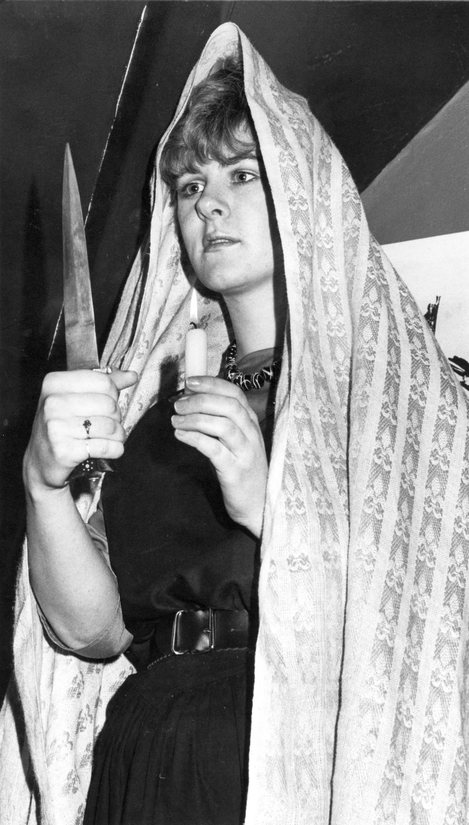 Young woman holding a dagger and candle at the counter-ceremony, 7 March 1985