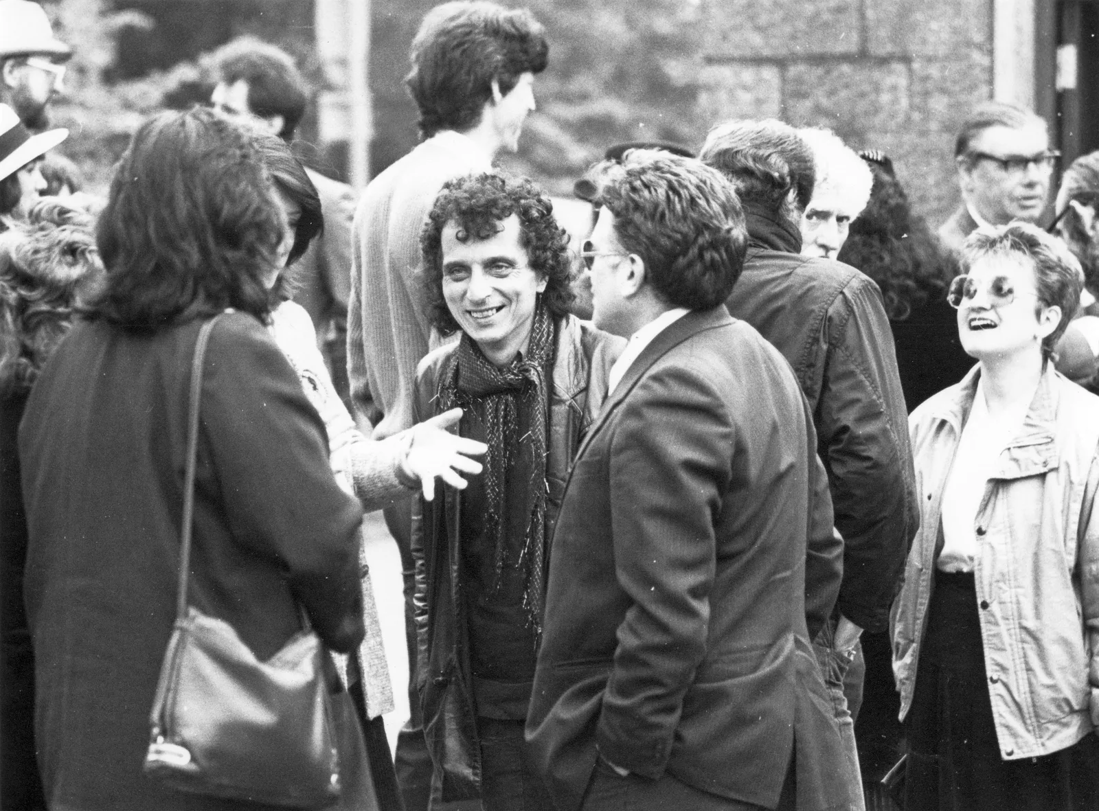 Group talking outside a stone building, probably Alex Sanders' funeral, 12 May 1988