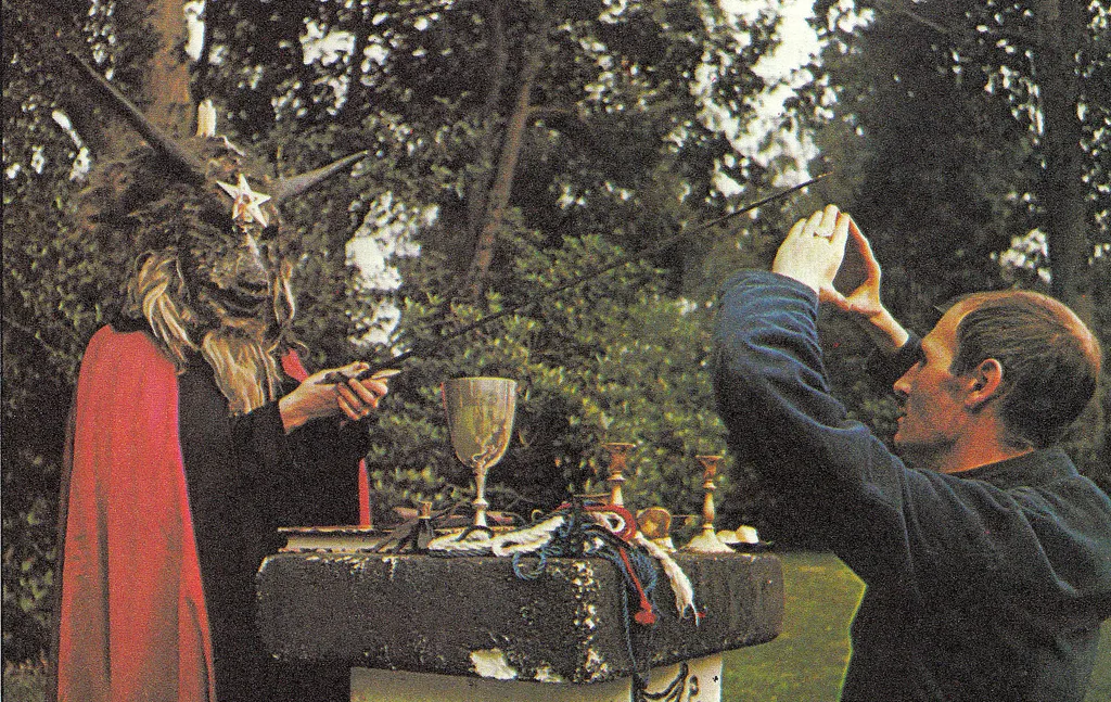 Image of Alex performing ritual with goat head