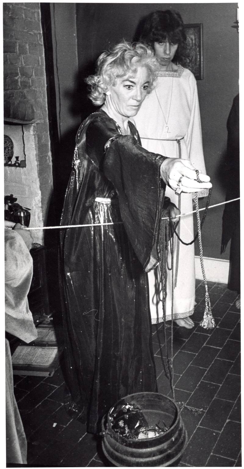 Betty Britton holding a cord over the cauldron, Chantry Cottage, 2 July 1974