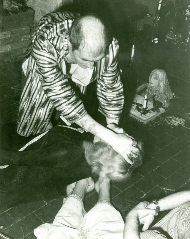 Alex Sanders with a coven member lying on the floor, Chantry Cottage, 23 April 1975