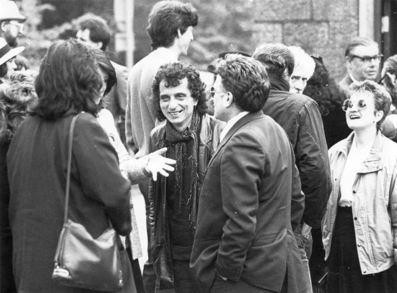 Group talking outside a stone building, probably Alex Sanders' funeral, 12 May 1988