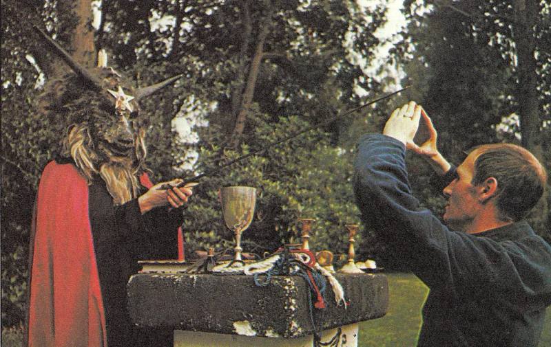 Image of Alex performing ritual with goat head